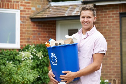 Workers using protective equipment during garden waste removal